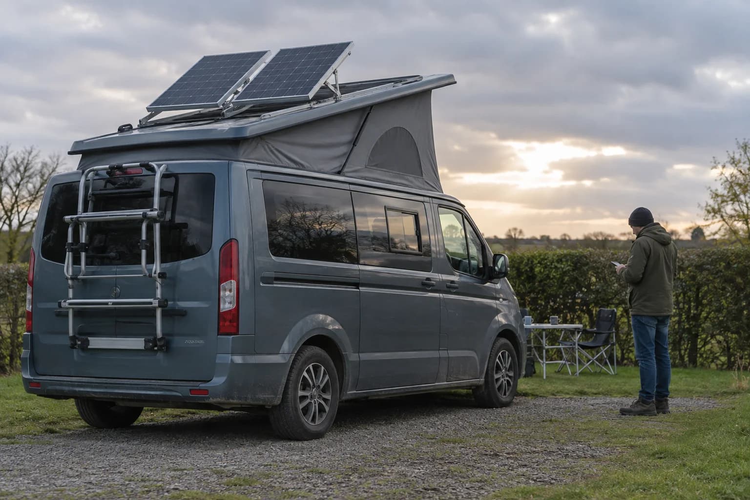 Illustrative editorial photograph of securely tilted solar panels on a stationary campervan; it is not a customer project record.