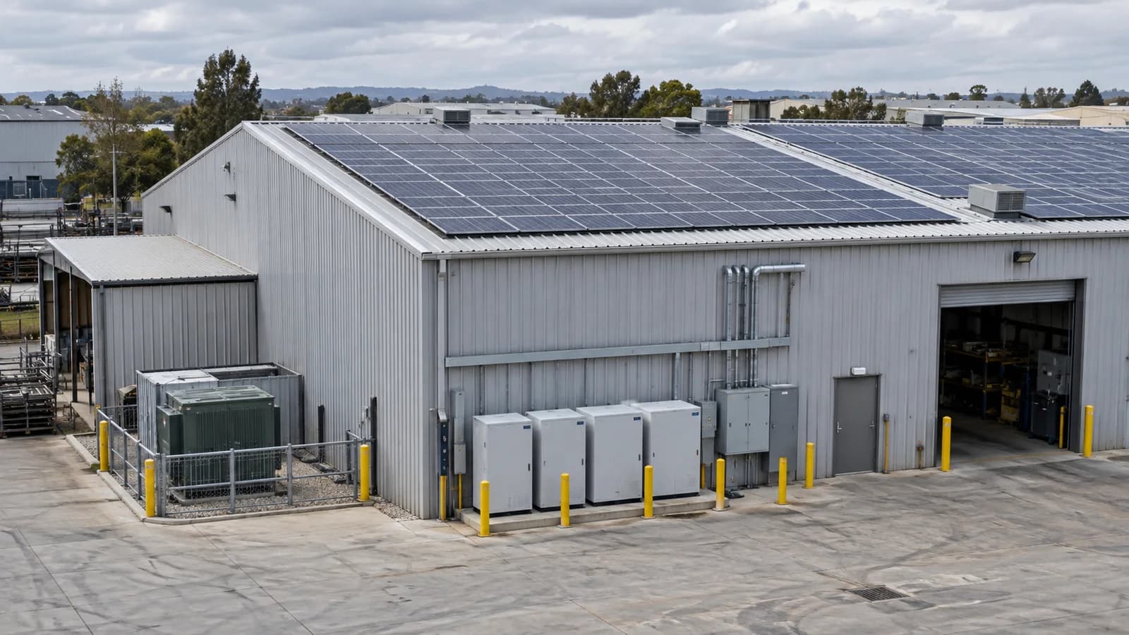 Rooftop solar panels and outdoor battery cabinets at a commercial building